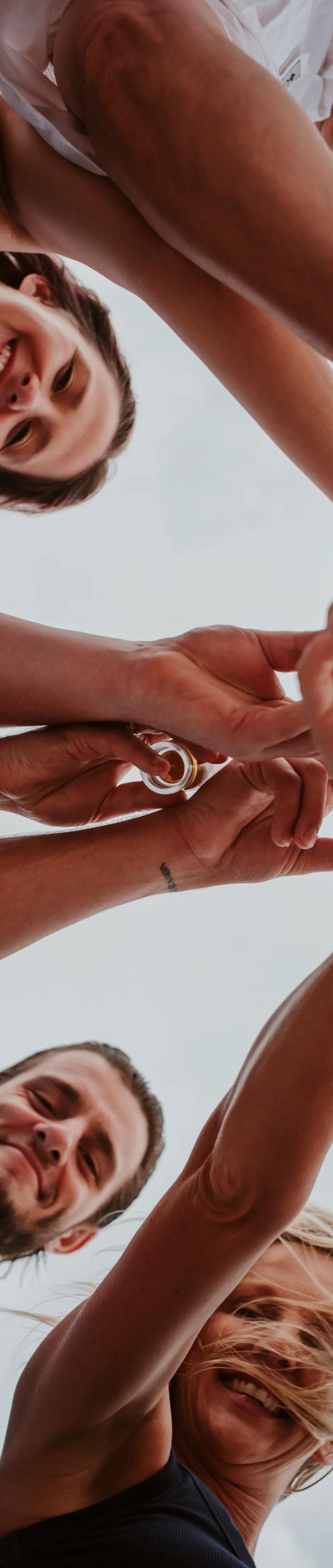 Family members raise their glasses together, seen from below